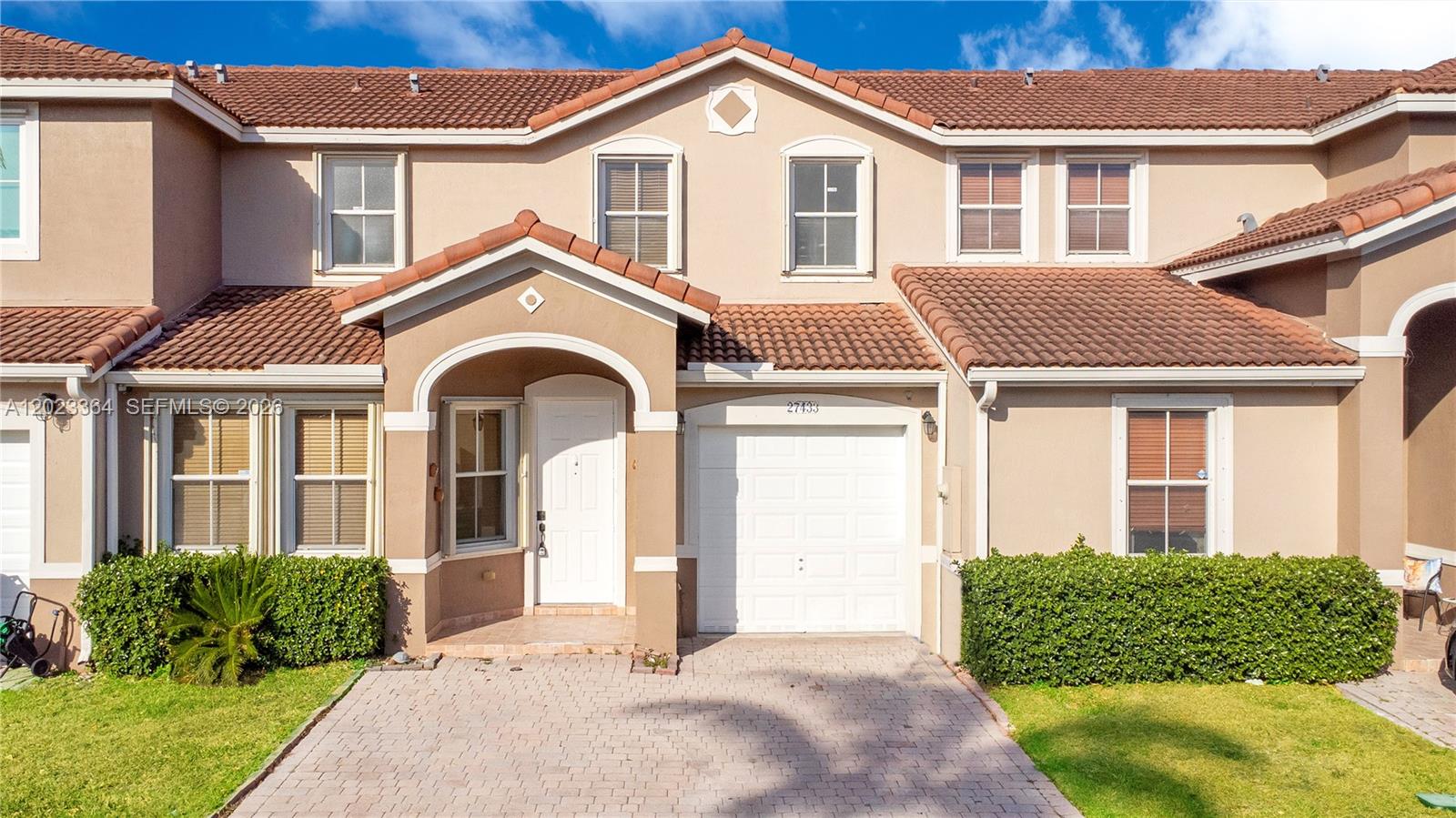 27433 Southwest 137th Court, Unit 1 Homestead, FL 33032 - Photo 2 of 28 a front view of a house with a yard