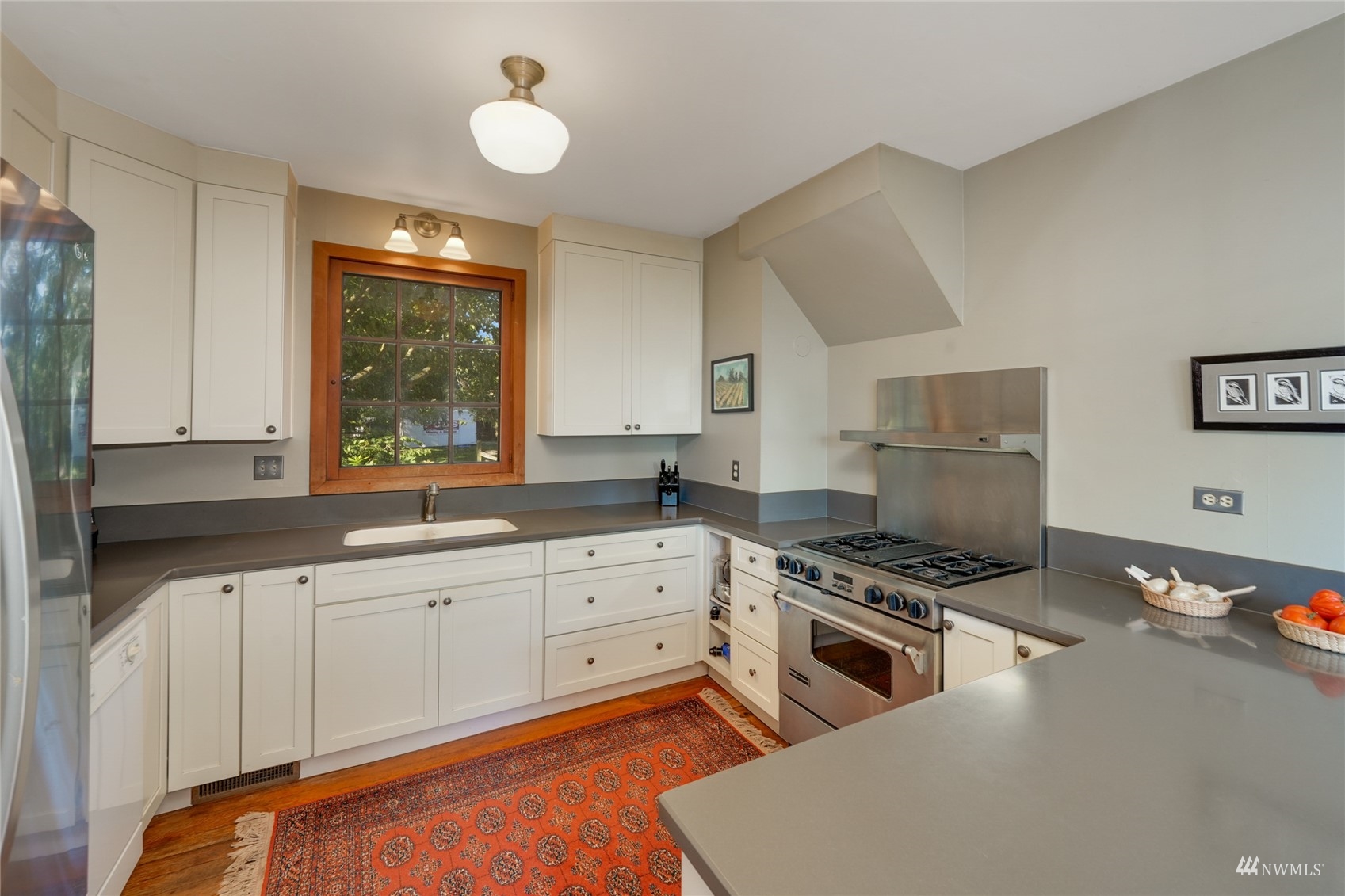 15816 Polson Road Mount Vernon, WA 98273 - Photo 8 of 40 a kitchen with granite countertop a stove a sink and a refrigerator