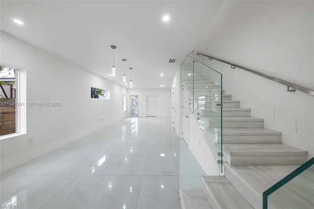 a view of a hallway with stairs