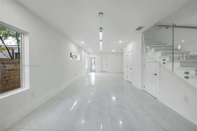 a large white kitchen with cabinets