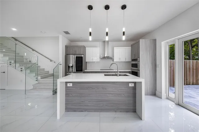 a kitchen that has a sink and a stove in it