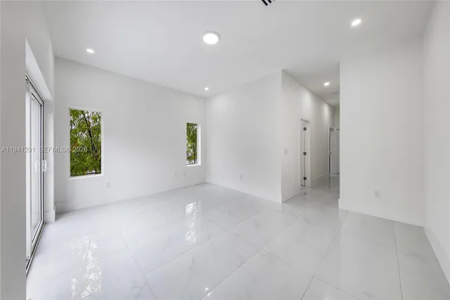 a bathroom with a granite countertop toilet a sink and a mirror