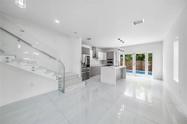 a kitchen with cabinets and stainless steel appliances