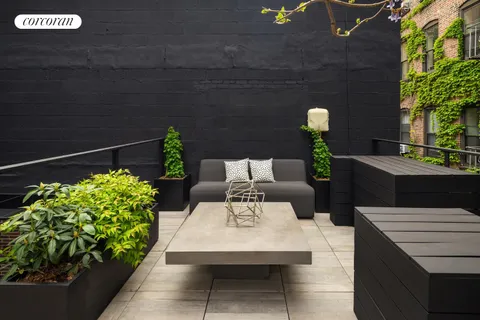 a outdoor space with the couches and a potted plant