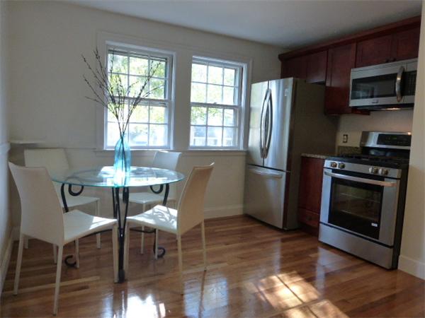 58 Ronald Road Arlington, MA 02474 - Photo 4 of 18 a kitchen with stainless steel appliances granite countertop a stove a refrigerator a dining table and chairs