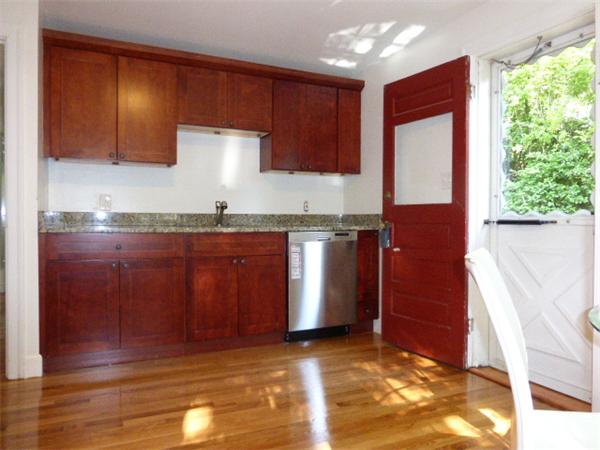 58 Ronald Road Arlington, MA 02474 - Photo 5 of 18 a kitchen with stainless steel appliances granite countertop wooden cabinets a refrigerator and sink
