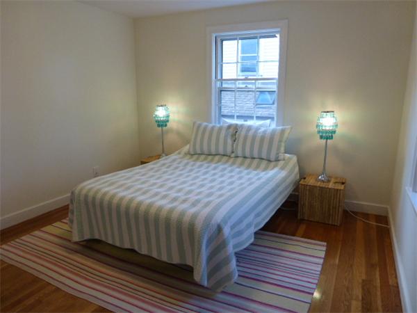 58 Ronald Road Arlington, MA 02474 - Photo 10 of 18 a bedroom with a bed and wooden floor