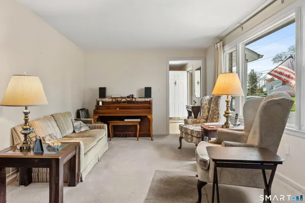 a living room with furniture a table and a lamp