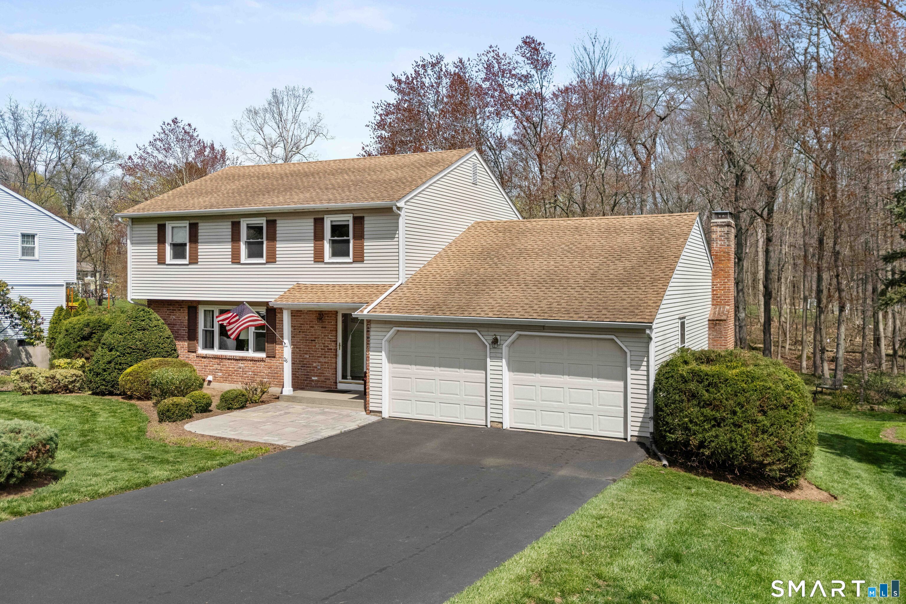 26 Seiter Hill Road Wallingford, CT 06492 - Photo 2 of 21 a front view of a house with a garden and garage