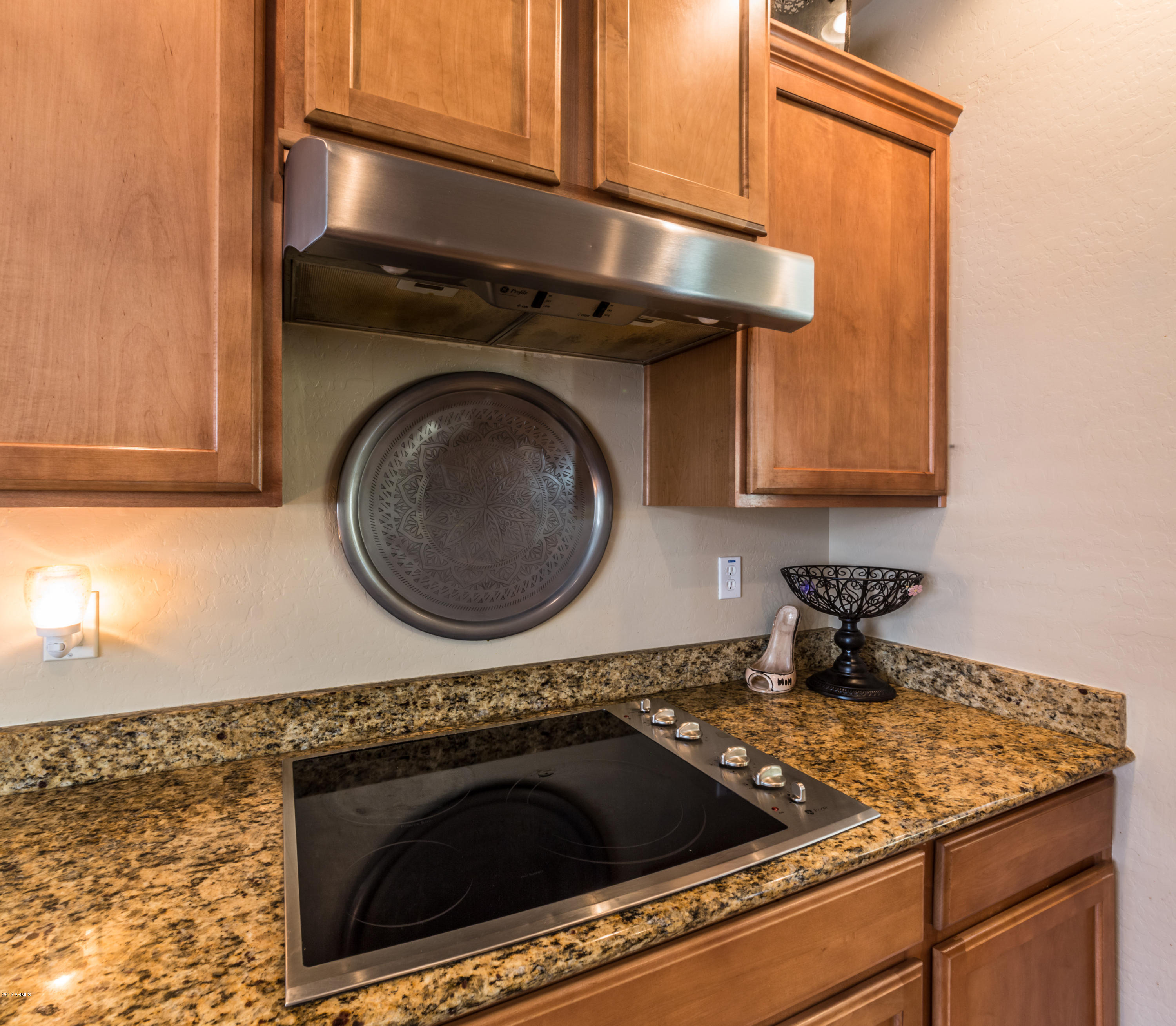 2872 North Point Ridge Road Buckeye, AZ 85396 - Photo 11 of 36 a kitchen with granite countertop a sink a stove and cabinets