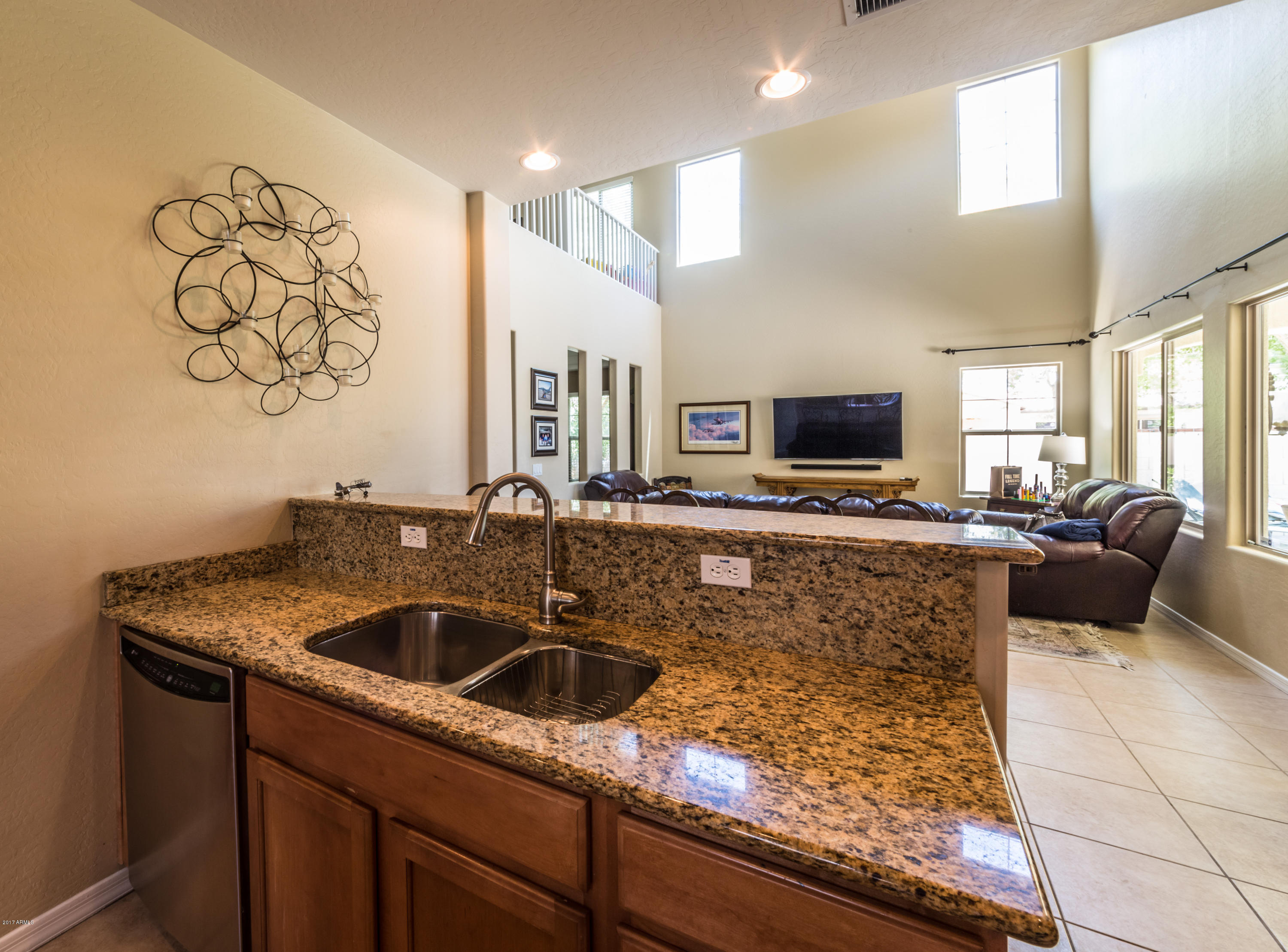 2872 North Point Ridge Road Buckeye, AZ 85396 - Photo 12 of 36 a kitchen with stainless steel appliances granite countertop a sink and a stove