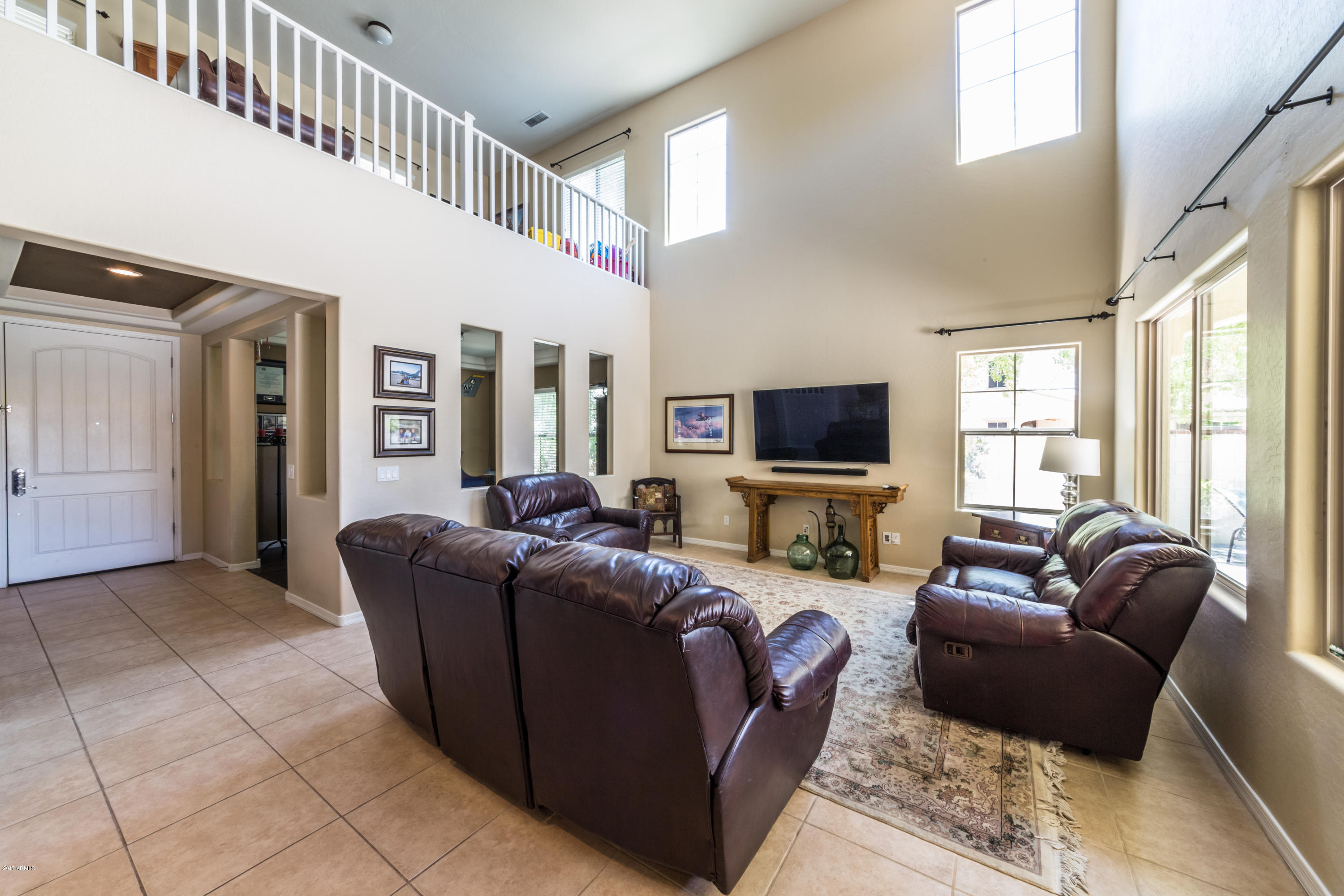 2872 North Point Ridge Road Buckeye, AZ 85396 - Photo 13 of 36 a living room with furniture window and a flat screen tv