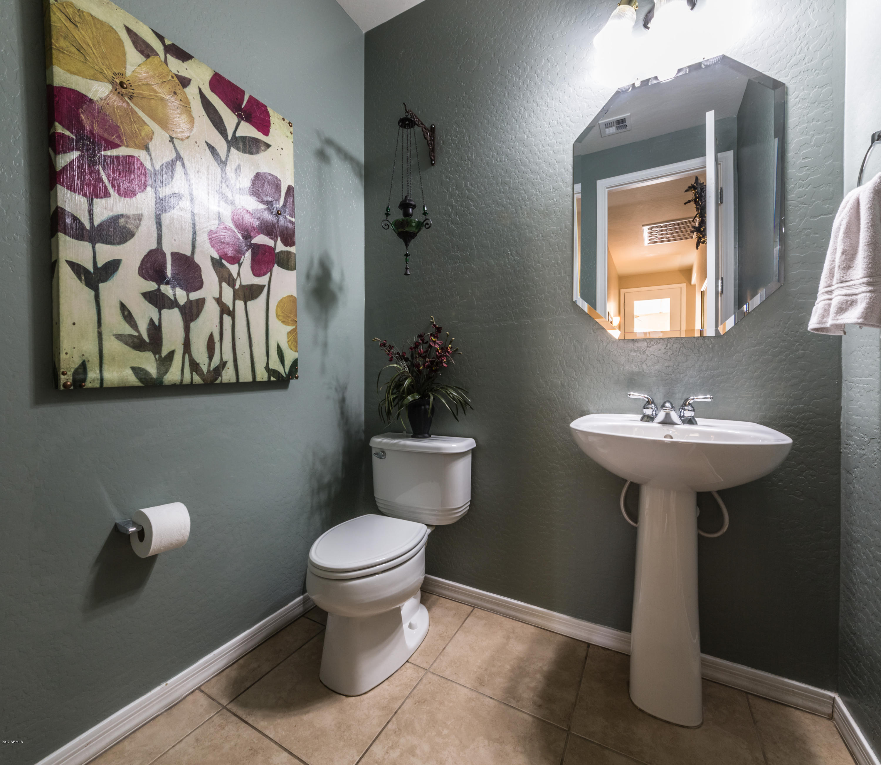 2872 North Point Ridge Road Buckeye, AZ 85396 - Photo 15 of 36 a bathroom with a sink toilet and mirror