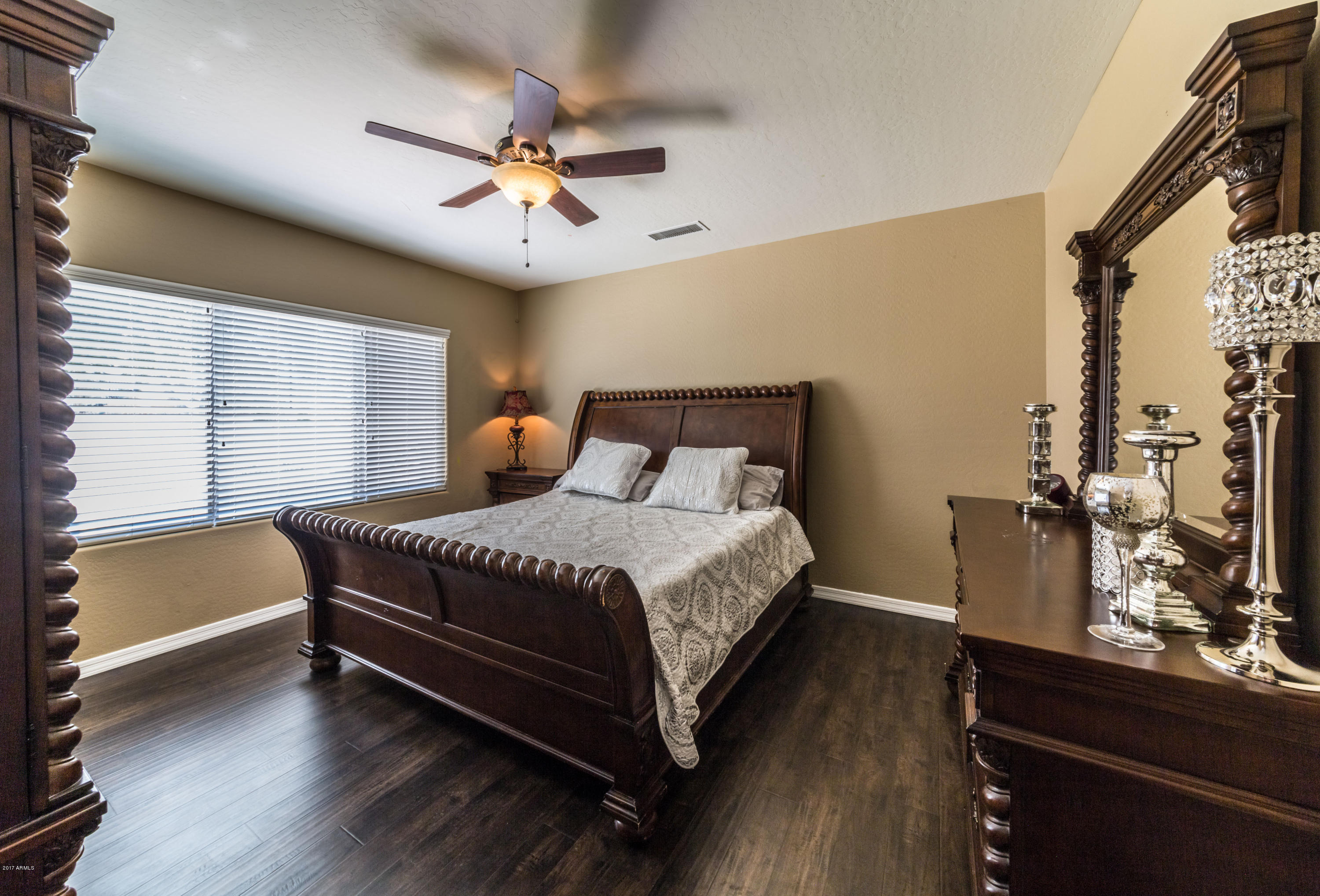 2872 North Point Ridge Road Buckeye, AZ 85396 - Photo 17 of 36 a large bed sitting in a bedroom next to a window
