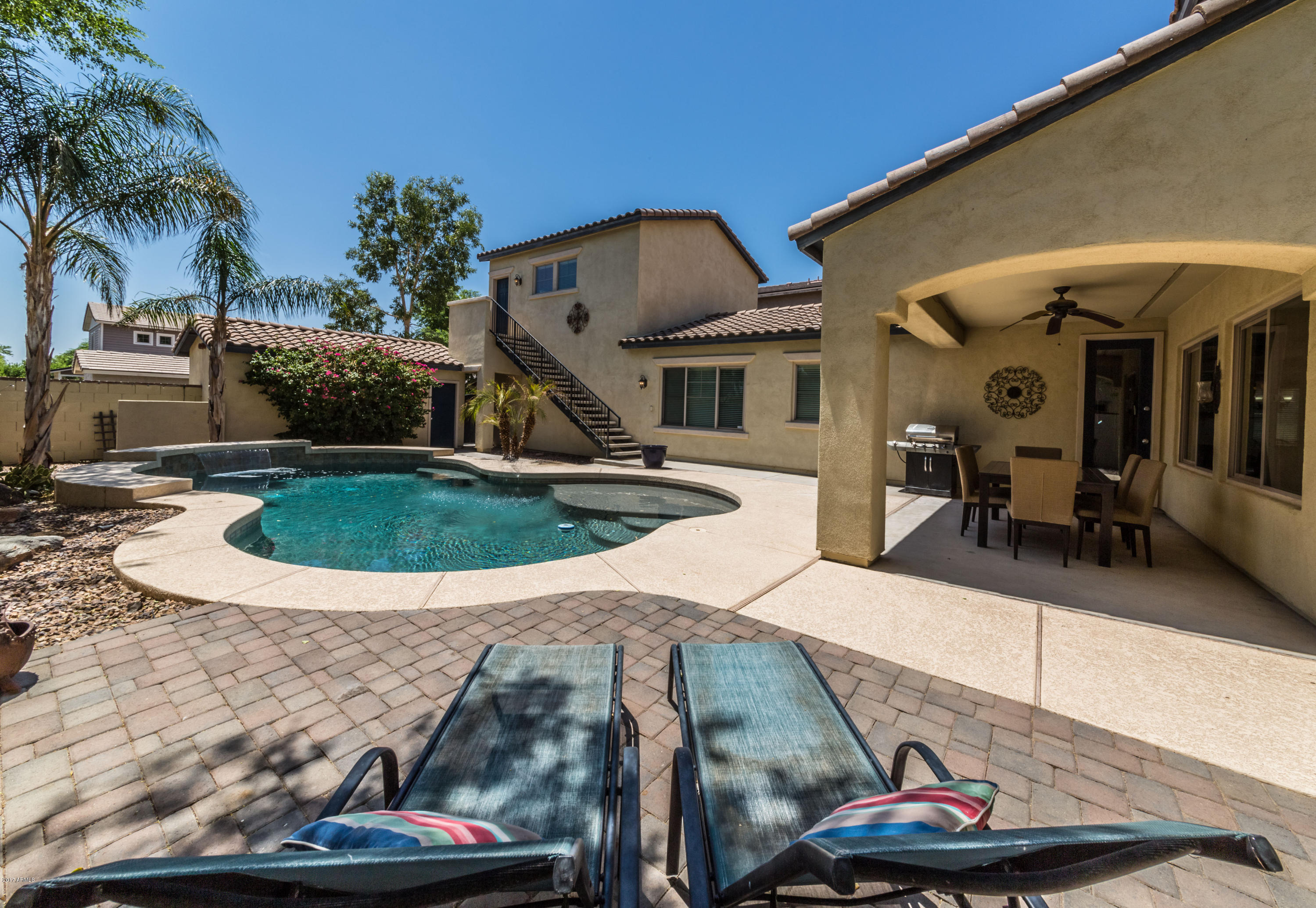 2872 North Point Ridge Road Buckeye, AZ 85396 - Photo 26 of 36 a view of a house with backyard water fountain and entertaining space