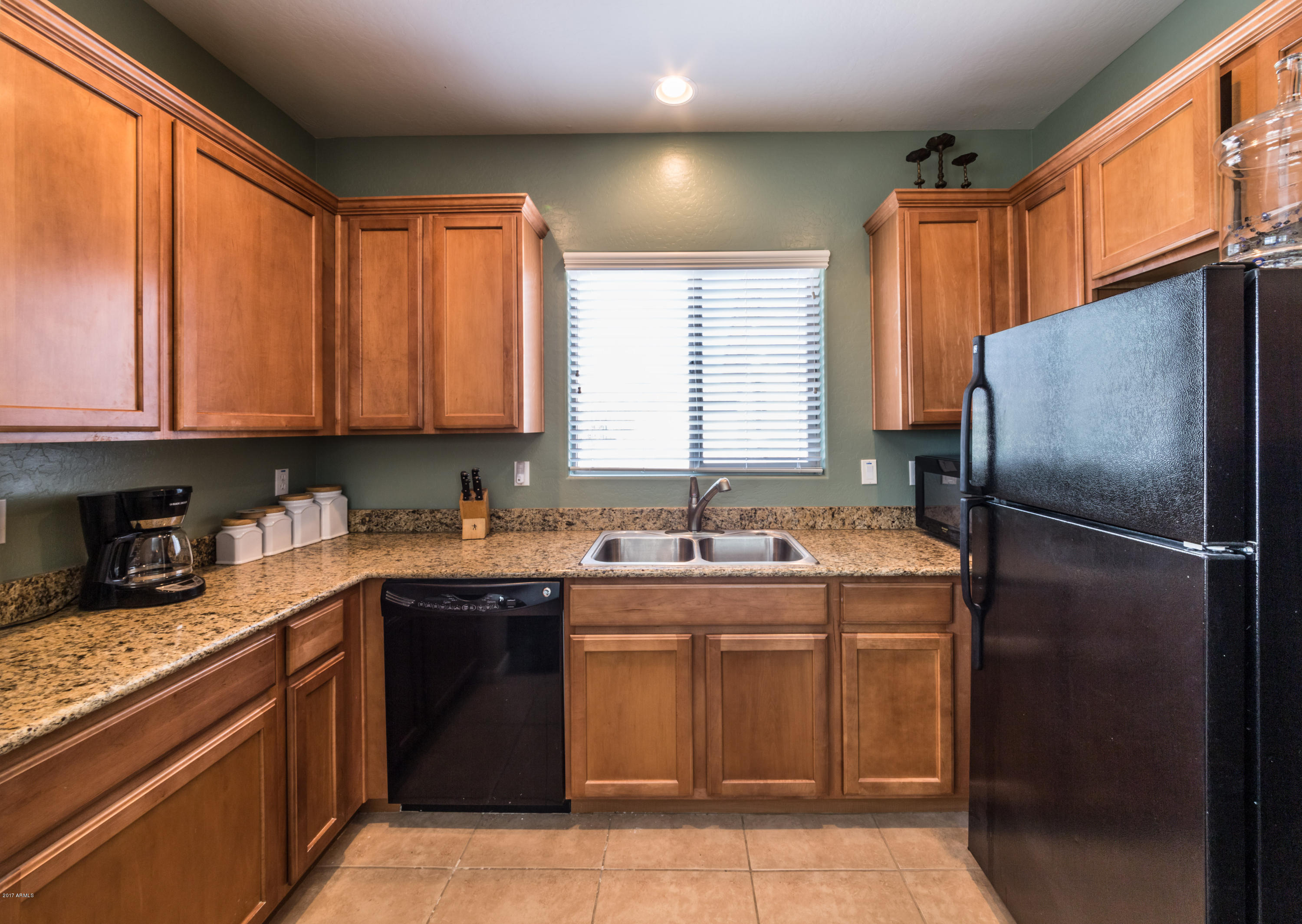 2872 North Point Ridge Road Buckeye, AZ 85396 - Photo 29 of 36 a kitchen with a sink stove and refrigerator