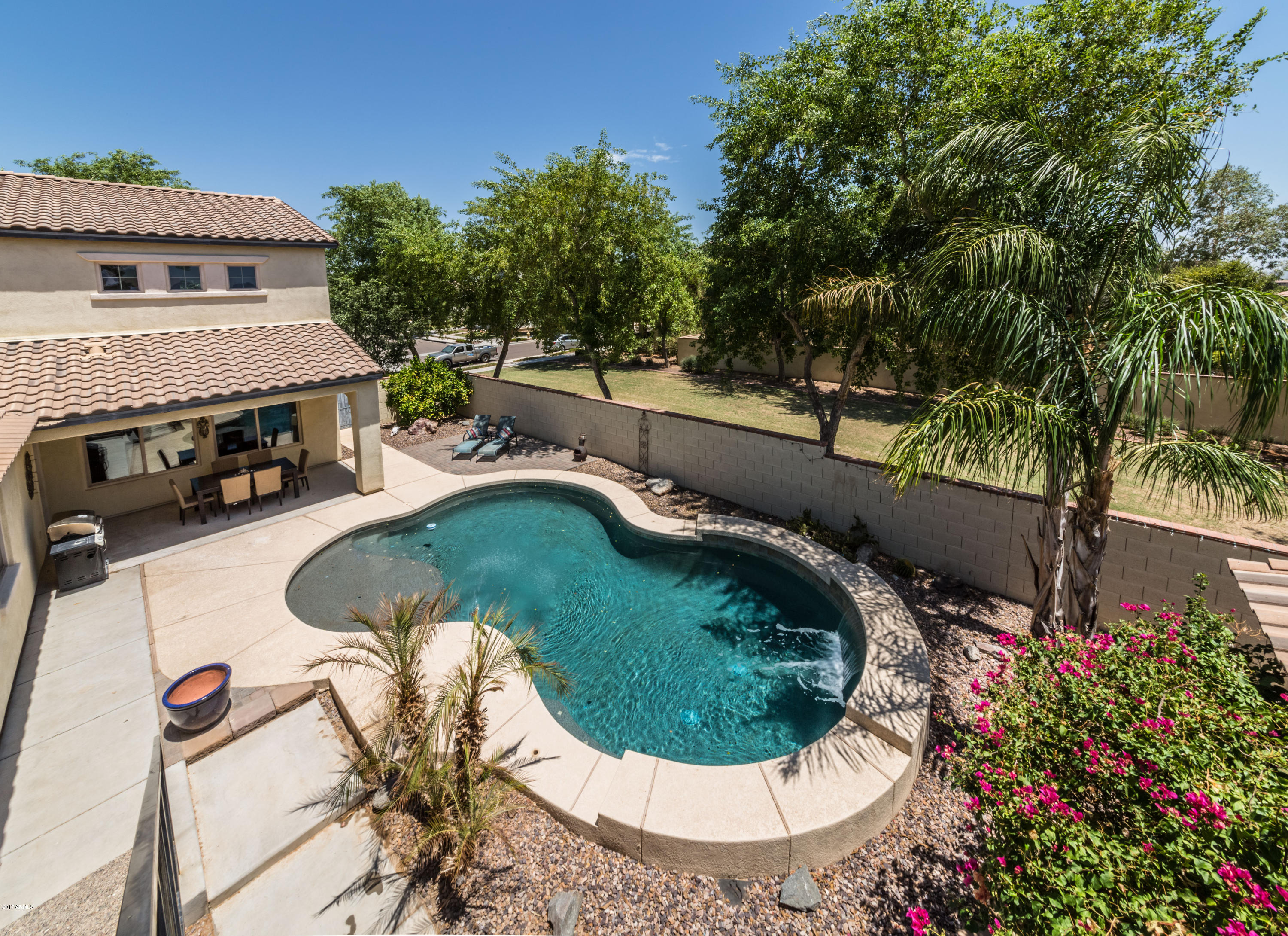 2872 North Point Ridge Road Buckeye, AZ 85396 - Photo 32 of 36 a swimming pool with trees in the background