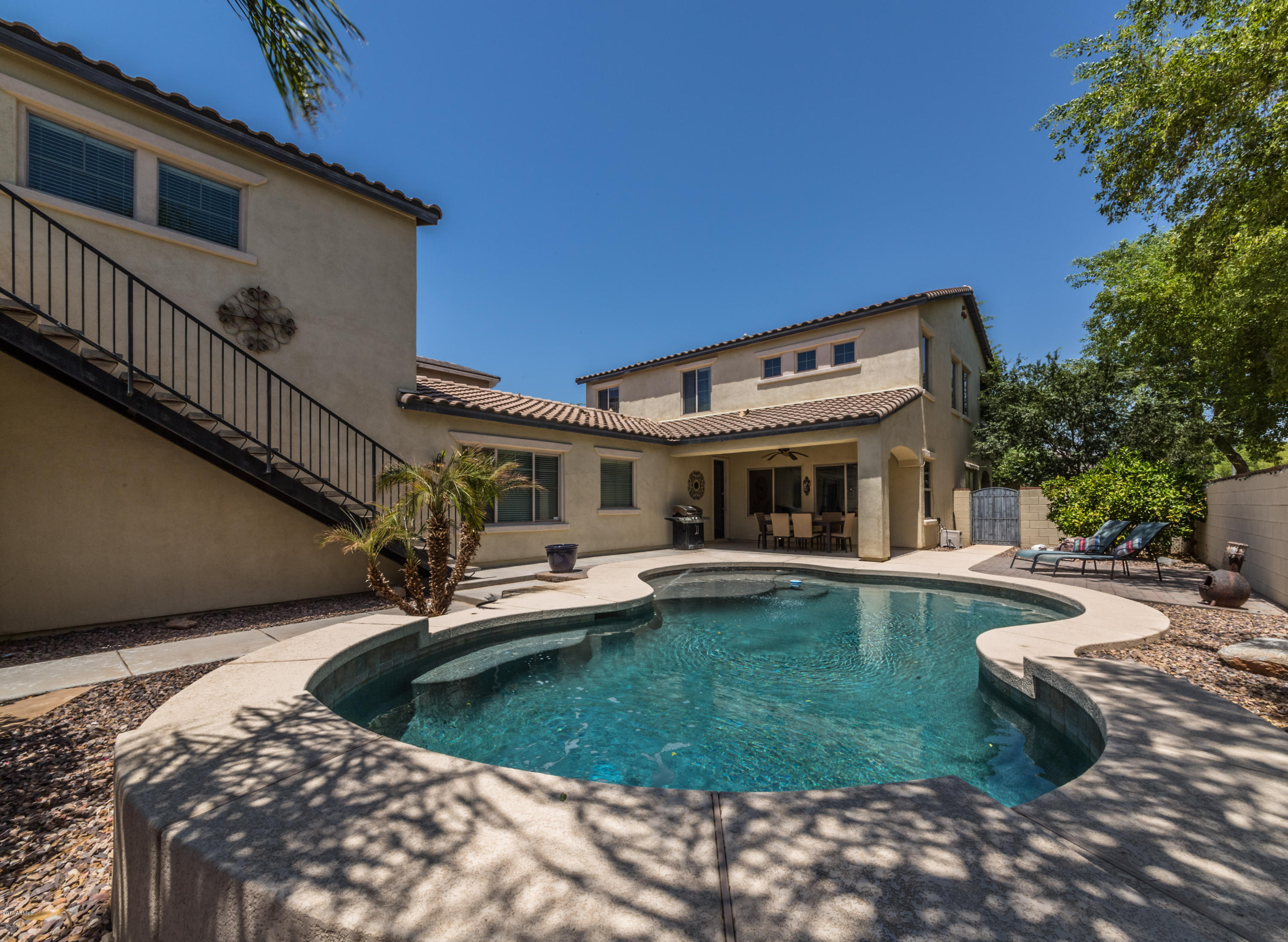 2872 North Point Ridge Road Buckeye, AZ 85396 - Photo 33 of 36 a view of a house with swimming pool and sitting area