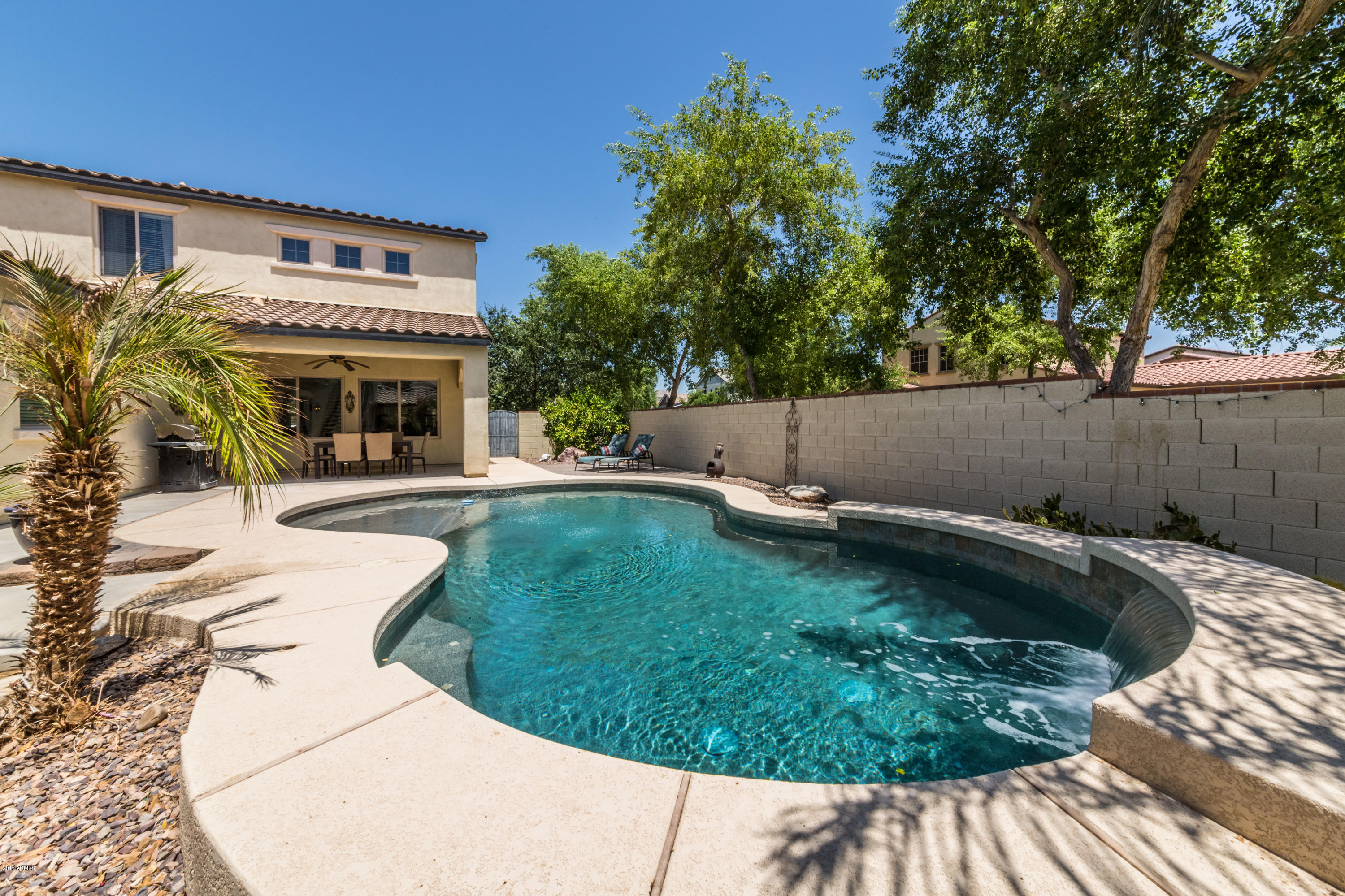 2872 North Point Ridge Road Buckeye, AZ 85396 - Photo 34 of 36 a view of swimming pool with a patio