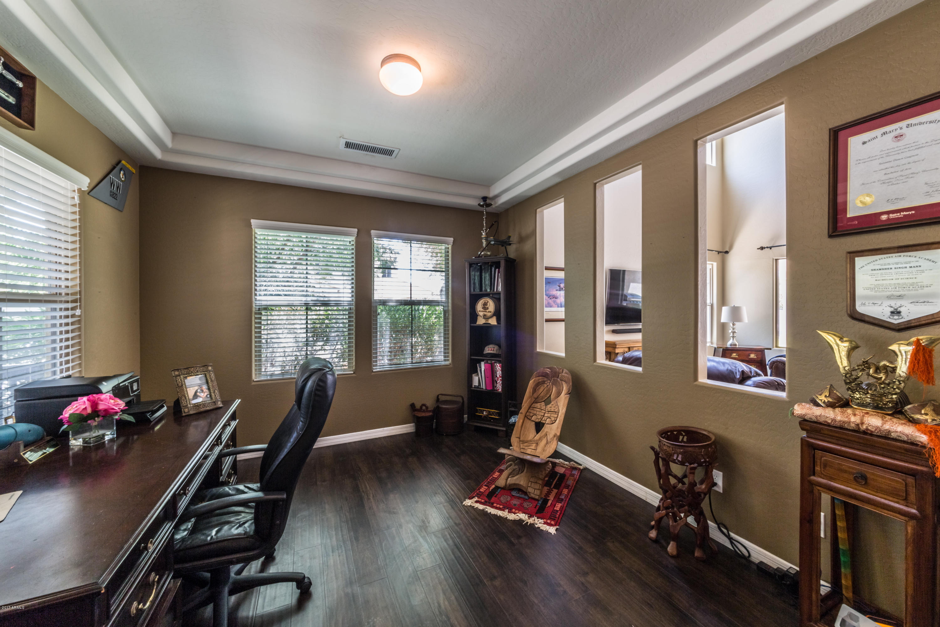 2872 North Point Ridge Road Buckeye, AZ 85396 - Photo 4 of 36 a room with furniture gym equipment and a large window