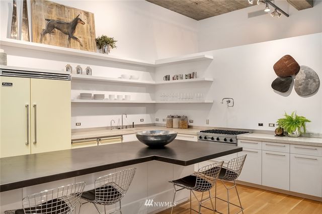 a kitchen with a table and chairs in it