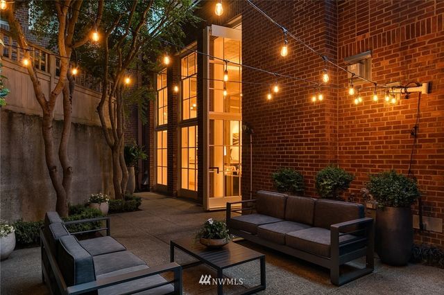 a living room with furniture and a potted plant