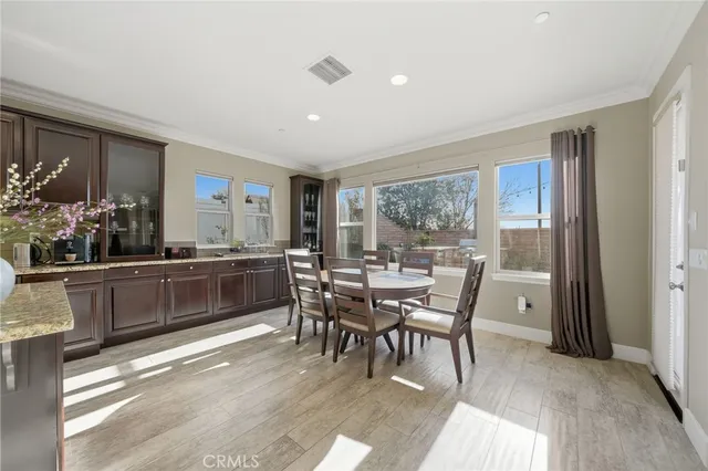 a dining room with furniture and wooden floor