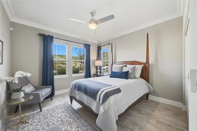 a bedroom with bed and large windows