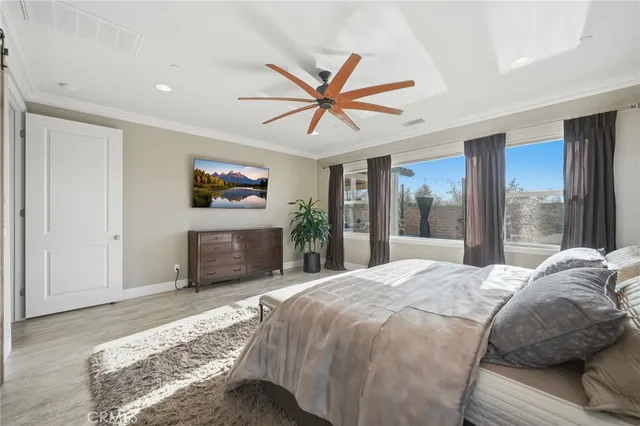 a bedroom with a bed and a large window