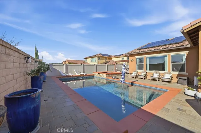 a view of a swimming pool with outdoor seating