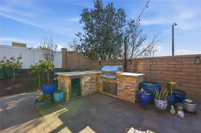 a view of a patio with table and chairs potted plants with wooden fence