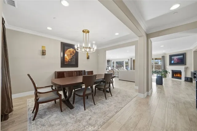a view of a dining room with furniture and chandelier