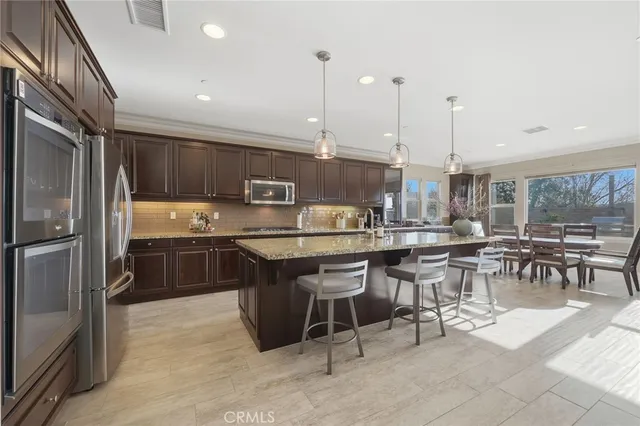 a kitchen with a large counter top appliances and cabinets