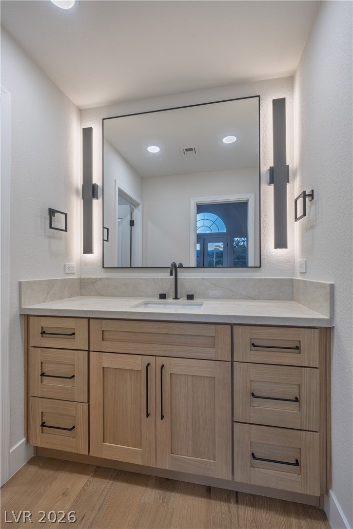 8800 Lusso Las Vegas, NV 89134 - Photo 69 of 85 Bathroom featuring vanity, a textured wall, light wood-style flooring, and recessed lighting