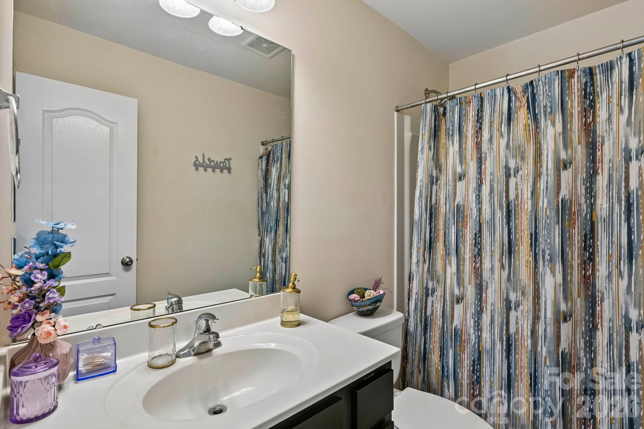 2206 Turtle Point Road Charlotte, NC 28262 - Photo 22 of 28 a bathroom with shower sink and mirror