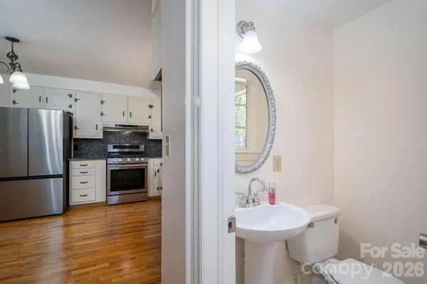 a view of a bedroom with wooden floor