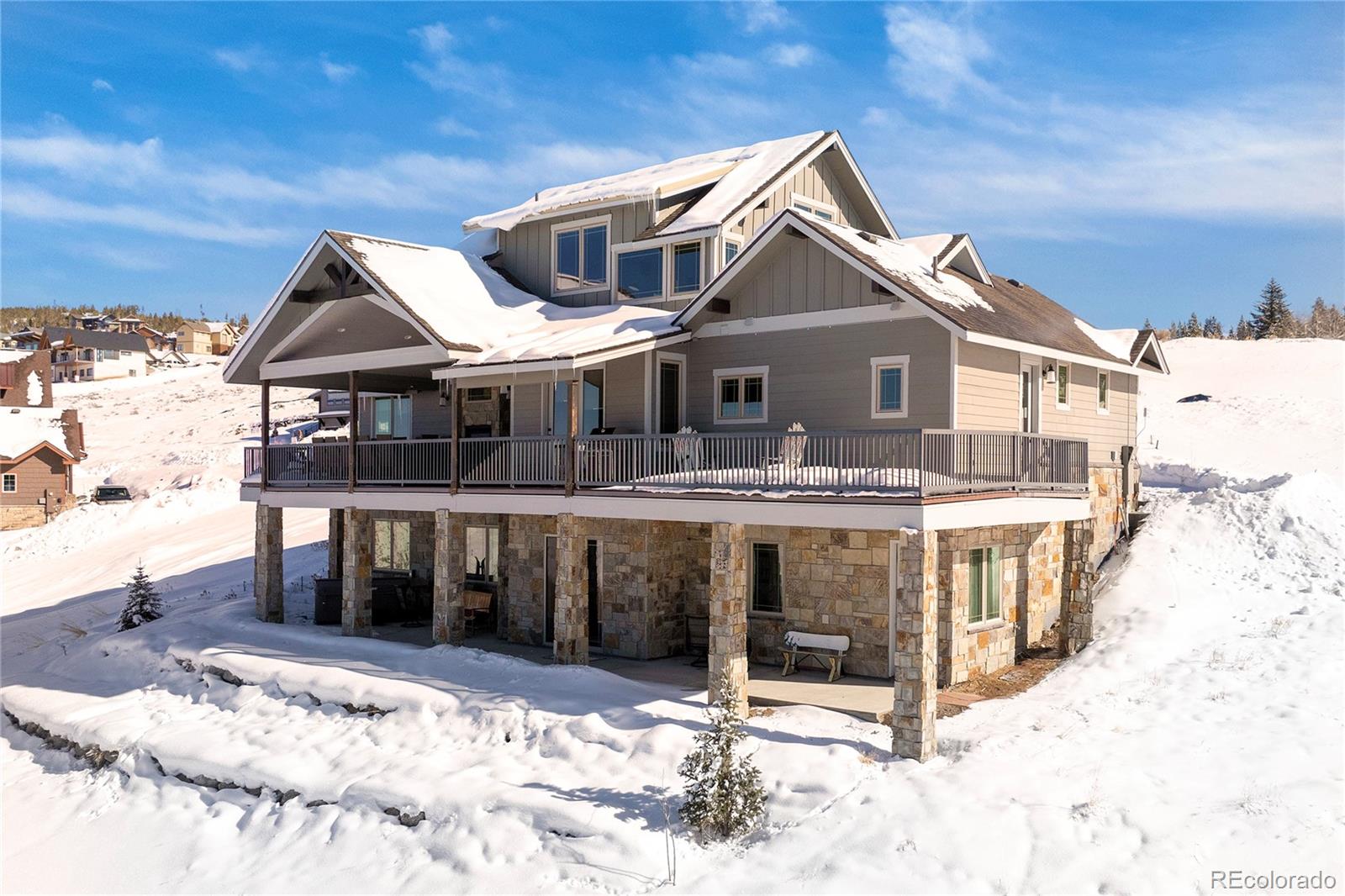 a front view of a house with a yard covered in snow