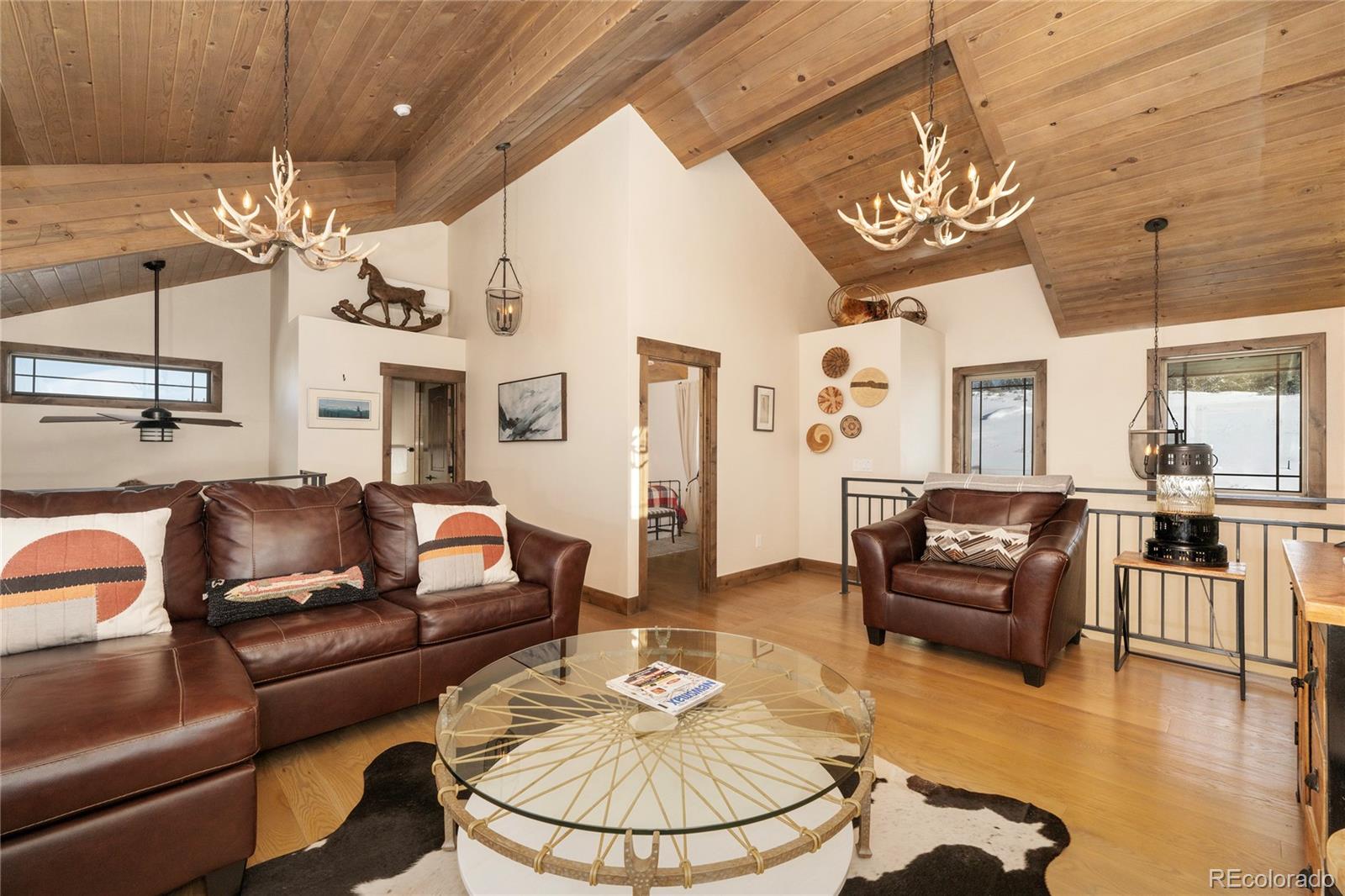 465 Lower Ranch View Drive Granby, CO 80446 - Photo 12 of 50 a living room with furniture a dining table and a chandelier