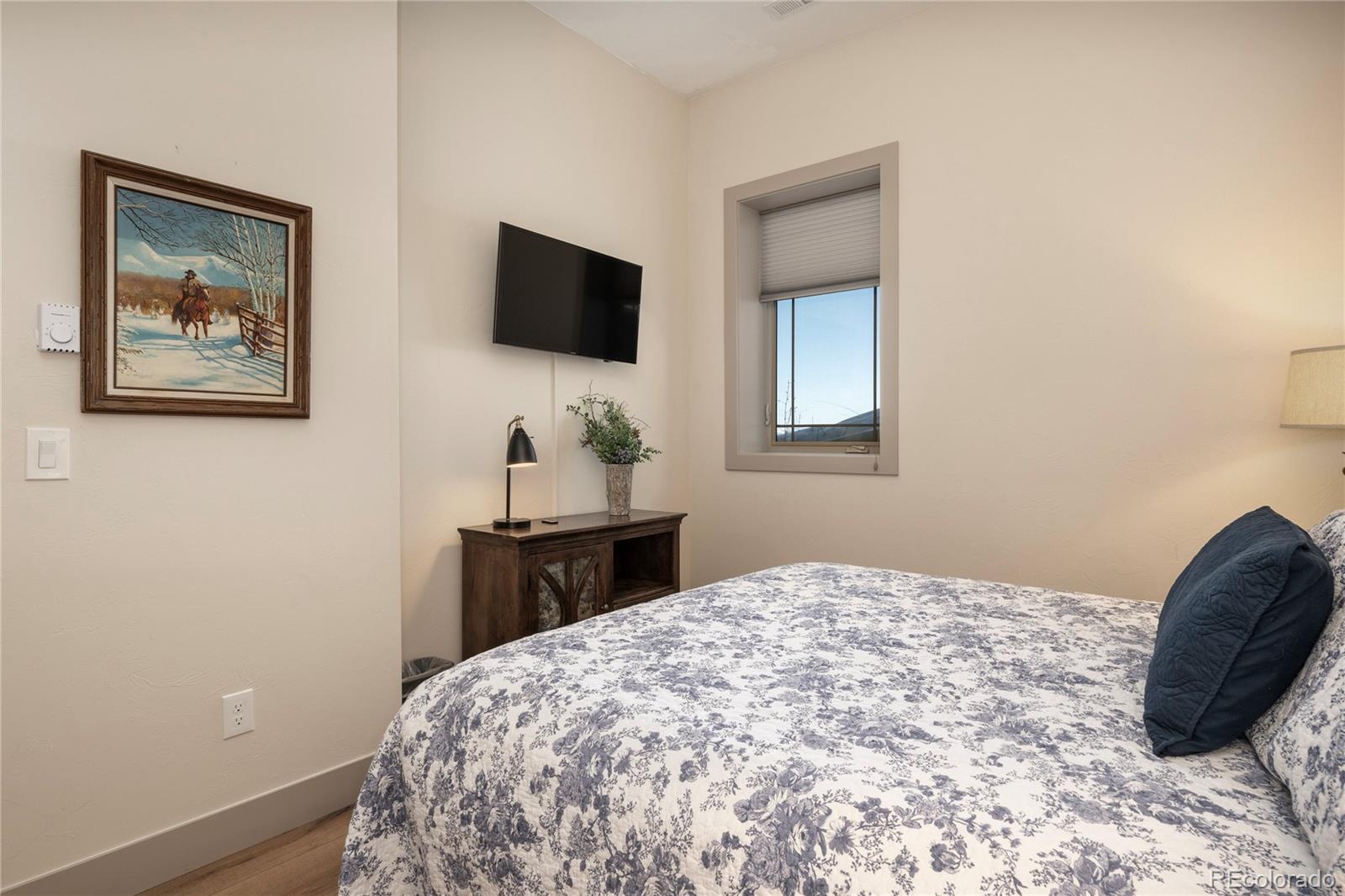 465 Lower Ranch View Drive Granby, CO 80446 - Photo 31 of 50 a bedroom with a bed and a flat screen tv