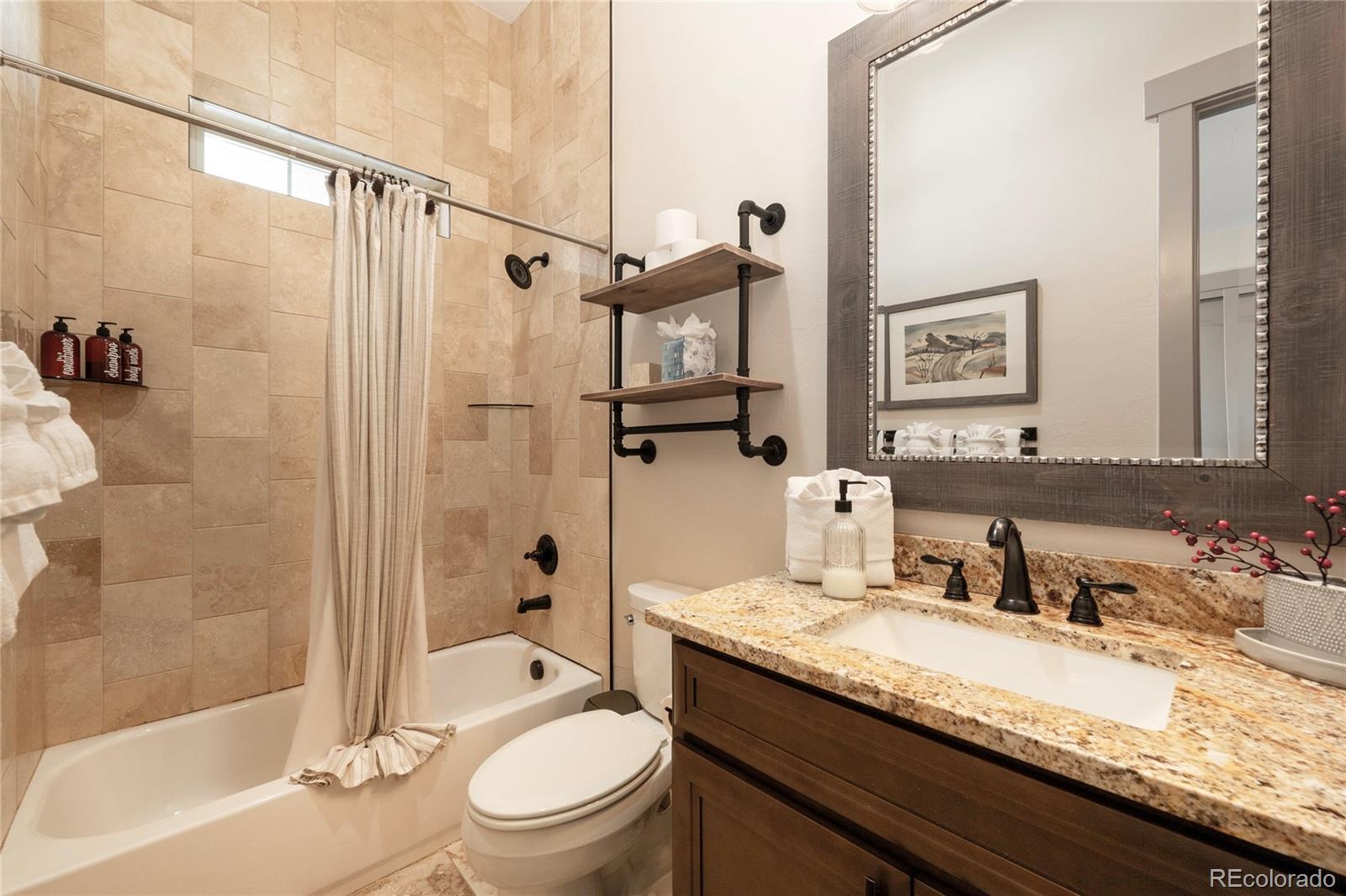 465 Lower Ranch View Drive Granby, CO 80446 - Photo 40 of 50 a bathroom with a granite countertop sink toilet and shower