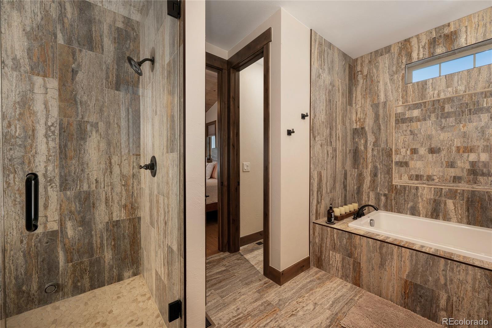 465 Lower Ranch View Drive Granby, CO 80446 - Photo 47 of 50 a bathroom with a tub and shower