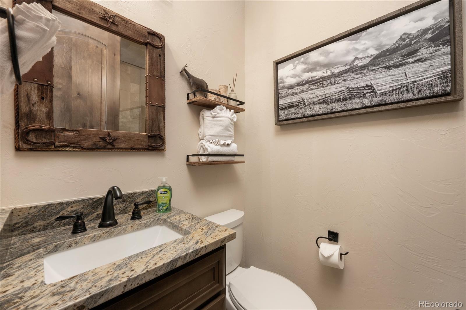 465 Lower Ranch View Drive Granby, CO 80446 - Photo 49 of 50 a bathroom with a granite countertop sink and a mirror