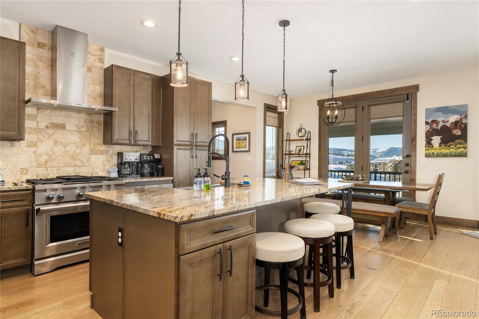 465 Lower Ranch View Drive Granby, CO 80446 - Photo 8 of 50 a kitchen with stainless steel appliances granite countertop a stove a sink a oven a dining table and chairs