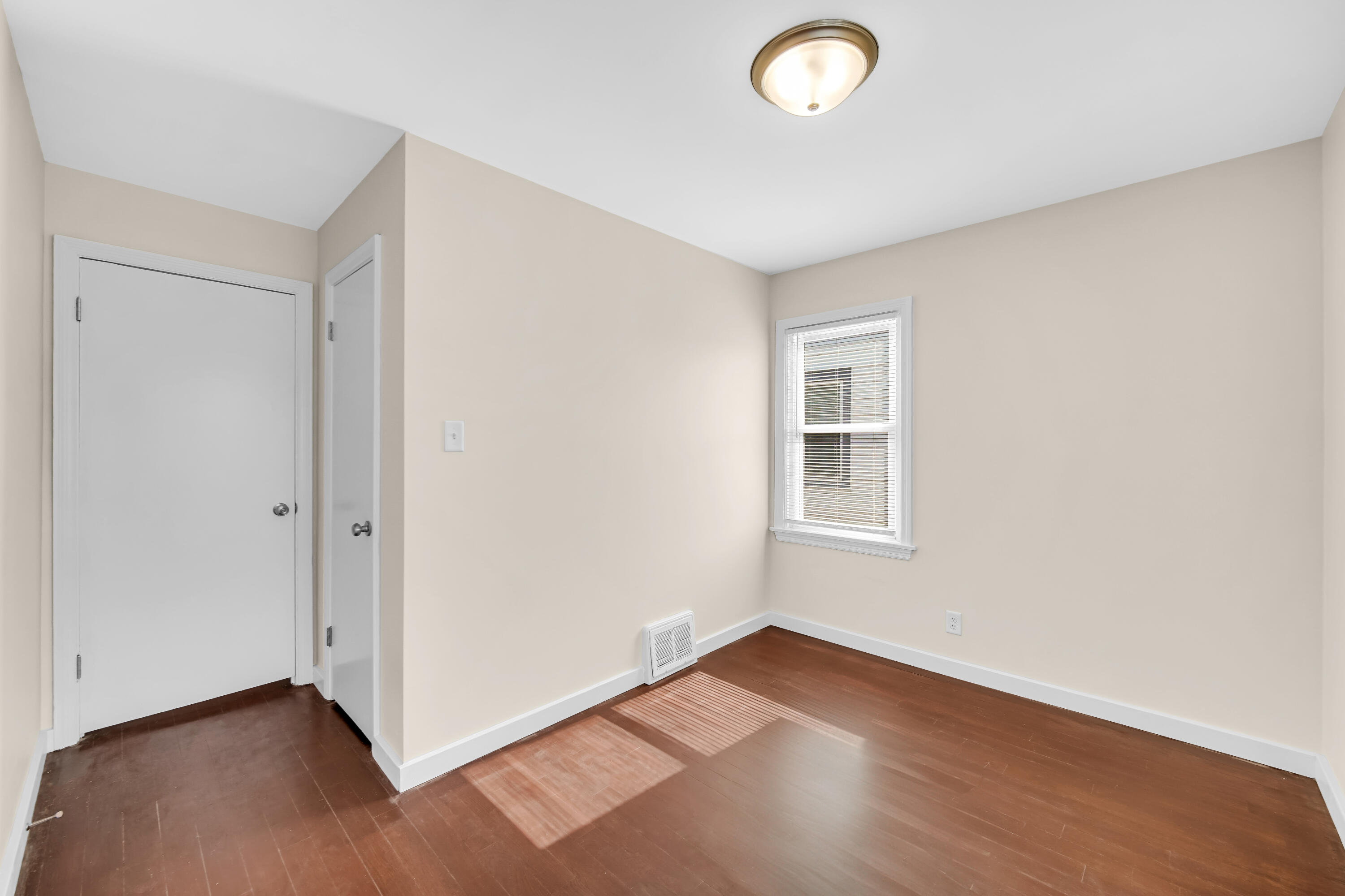 2726 162nd Place Hammond, IN 46323 - Photo 12 of 18 an empty room with wooden floor and windows