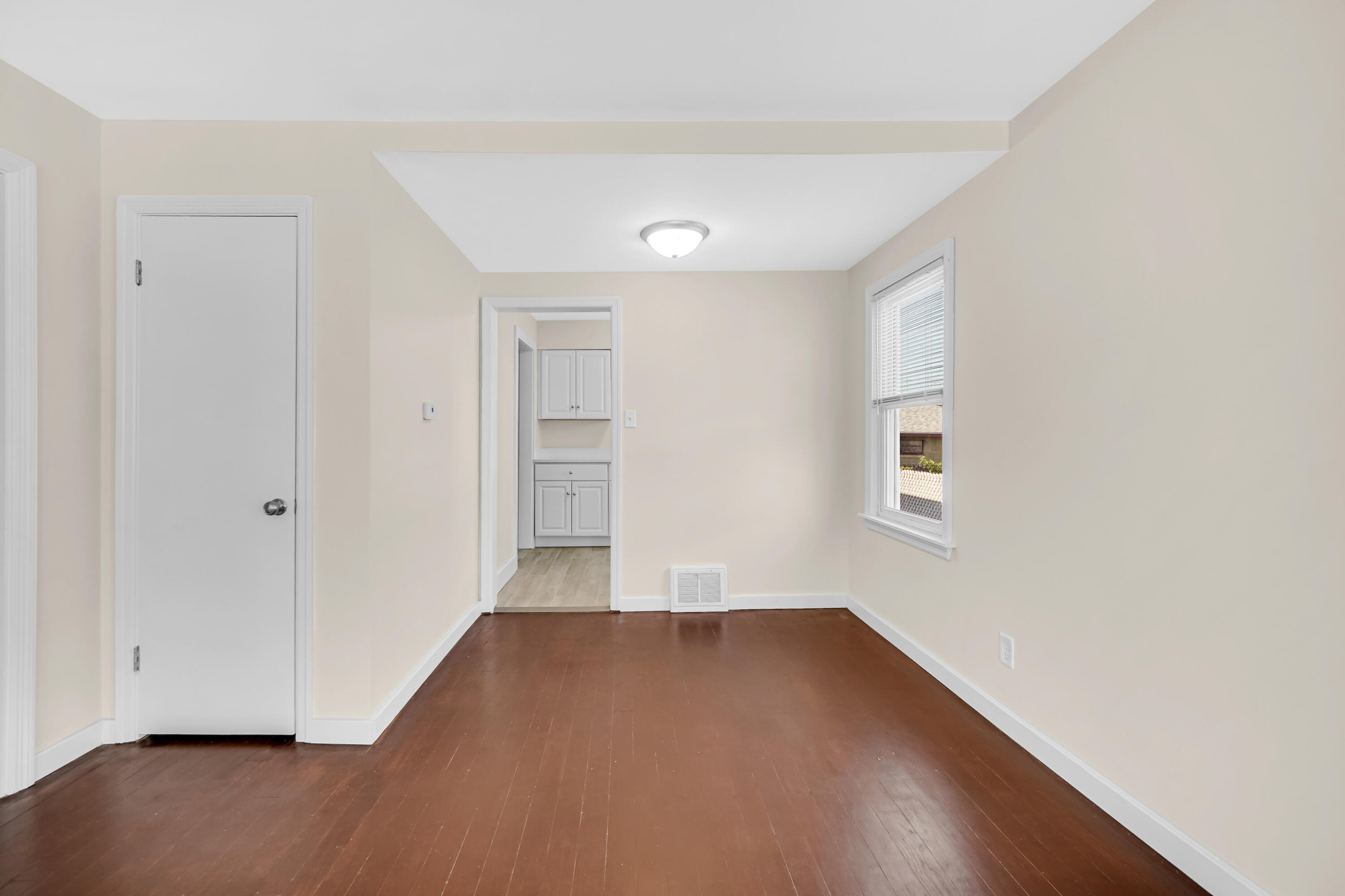 2726 162nd Place Hammond, IN 46323 - Photo 5 of 18 an empty room with wooden floor and windows