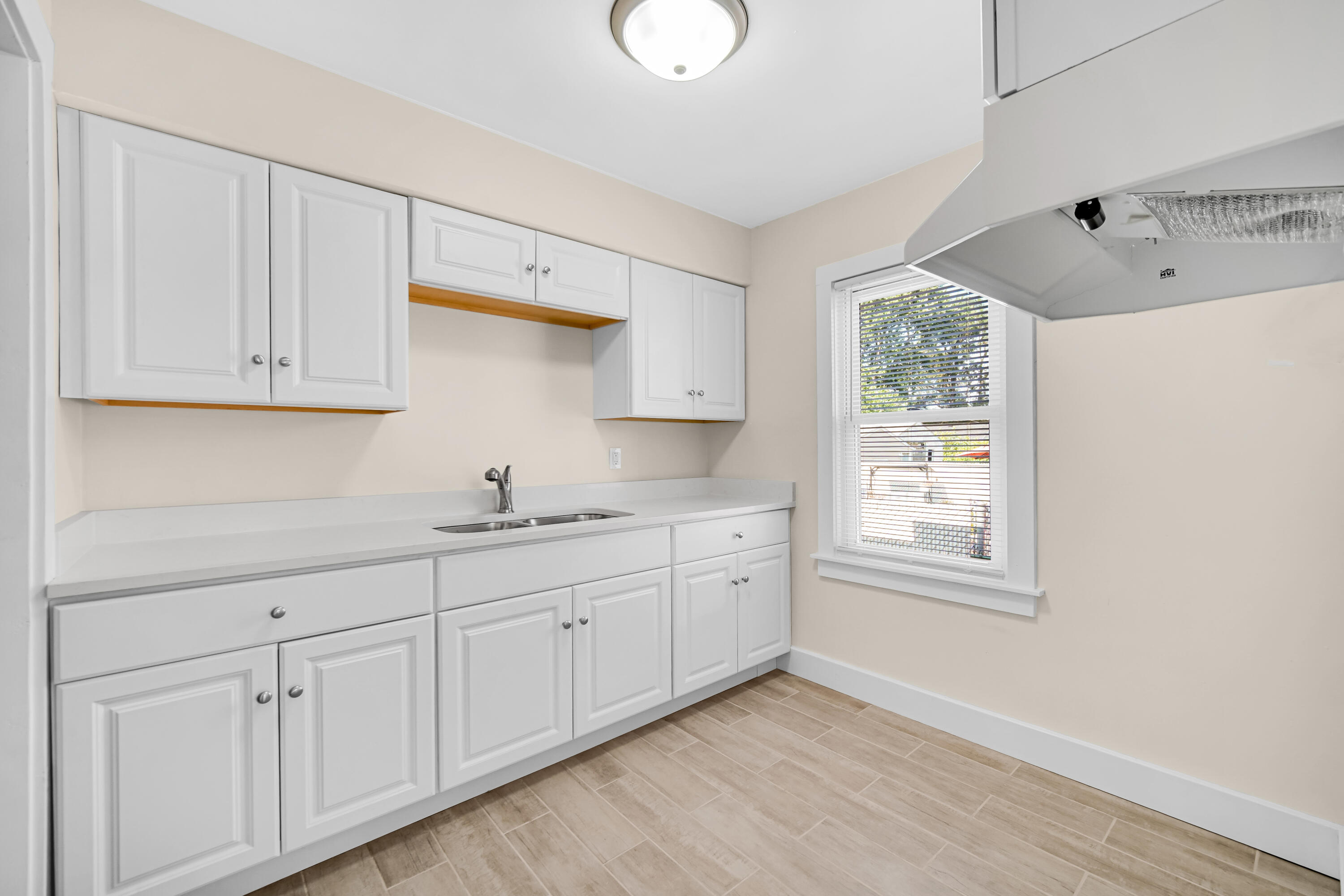 2726 162nd Place Hammond, IN 46323 - Photo 6 of 18 a kitchen with sink cabinets and window