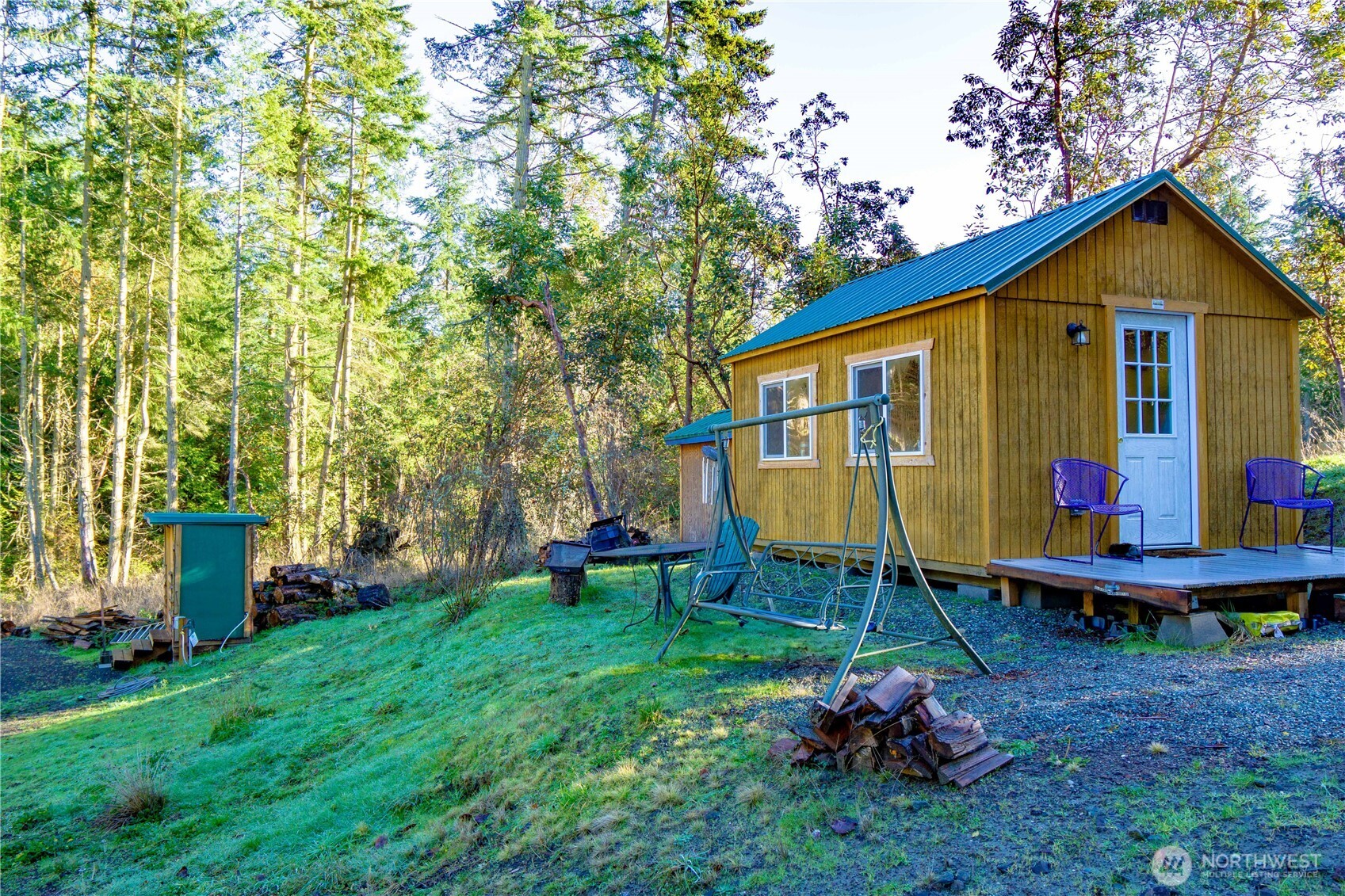 995 Kirner Road Sequim, WA 98382 - Photo 18 of 31 a view of a backyard with wooden fence and a bench
