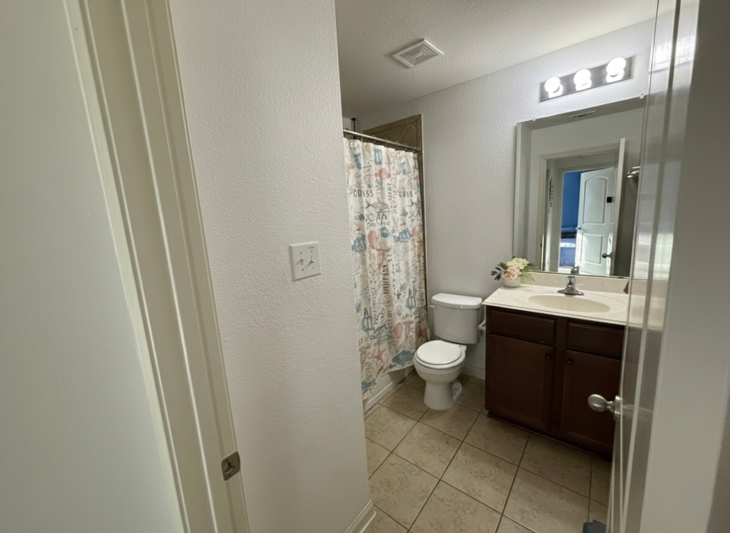 108 Koontz Loop Jarrell, TX 76537 - Photo 14 of 20 Full bathroom with a textured wall, vanity, curtained shower, light tile patterned floors, and a textured ceiling