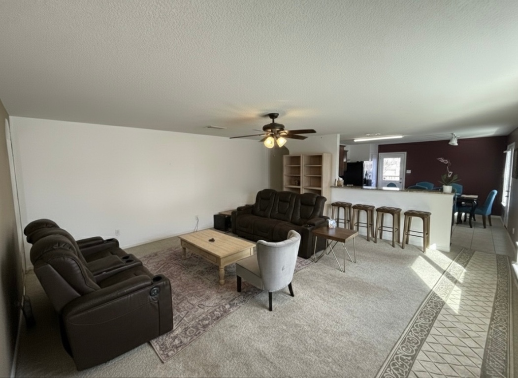108 Koontz Loop Jarrell, TX 76537 - Photo 2 of 20 Living room with a textured ceiling, light colored carpet, and ceiling fan