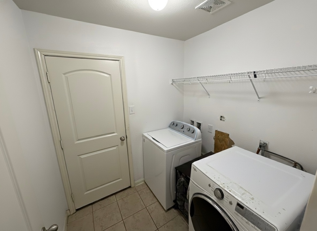 108 Koontz Loop Jarrell, TX 76537 - Photo 9 of 20 Laundry room with light tile patterned floors and separate washer and dryer